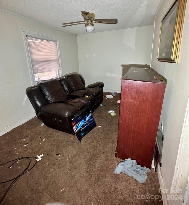 carpeted living room featuring a textured ceiling and ceiling fan