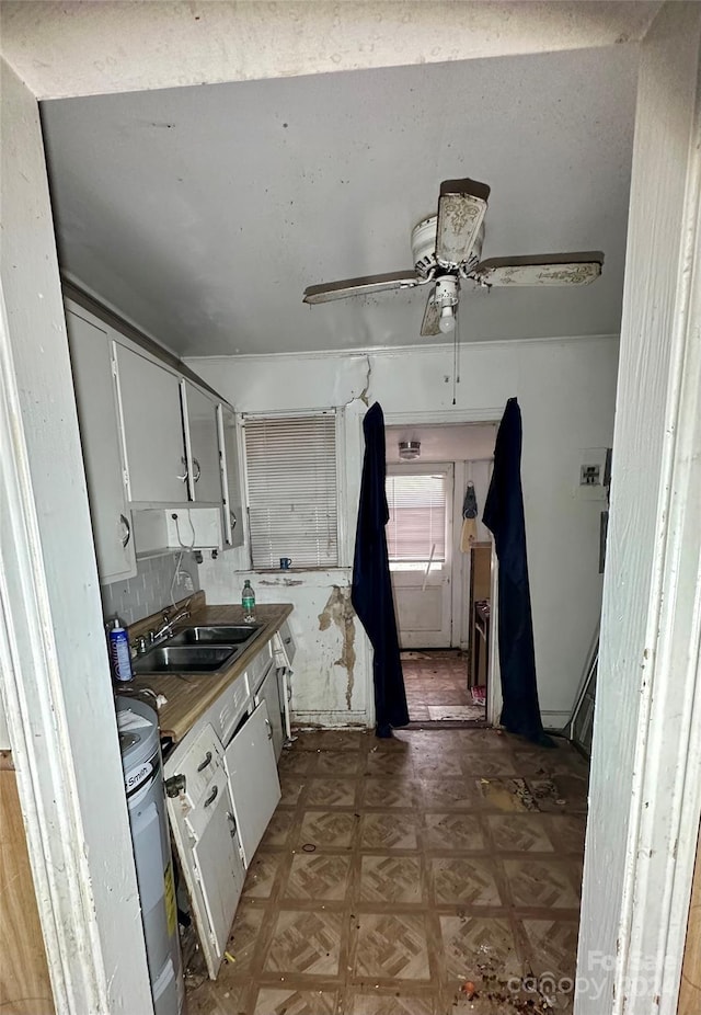 kitchen featuring white cabinets, dark parquet floors, electric water heater, and sink