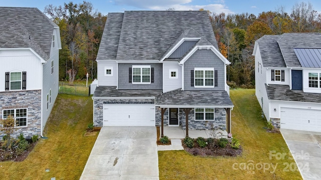 view of front of property with a front lawn and a garage