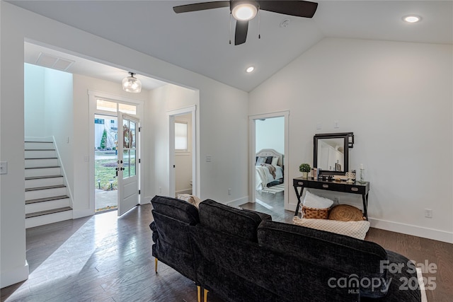 living room featuring ceiling fan, dark hardwood / wood-style floors, and vaulted ceiling