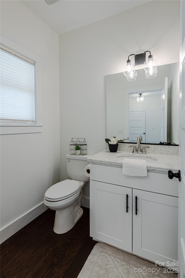 bathroom featuring hardwood / wood-style floors, toilet, and vanity