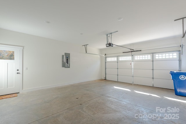 garage with a garage door opener and electric panel