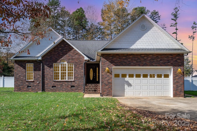 view of front facade featuring a garage and a yard