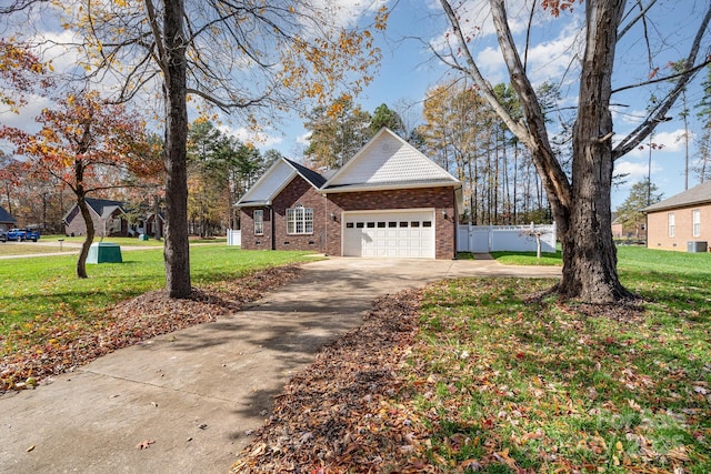 view of front of home featuring a front yard, a garage, and central air condition unit