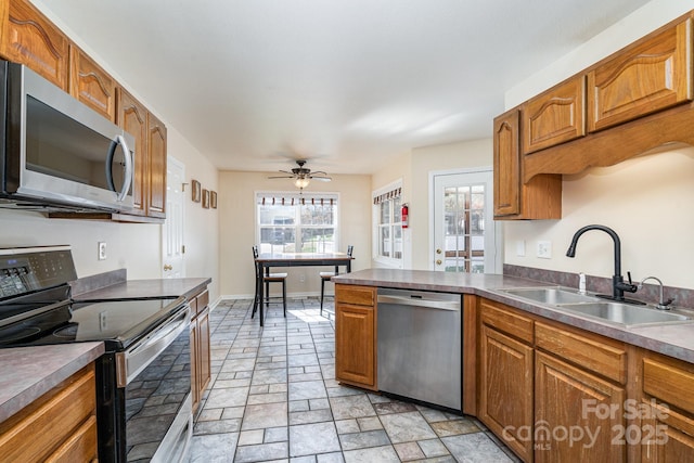 kitchen featuring stainless steel appliances, ceiling fan, and sink