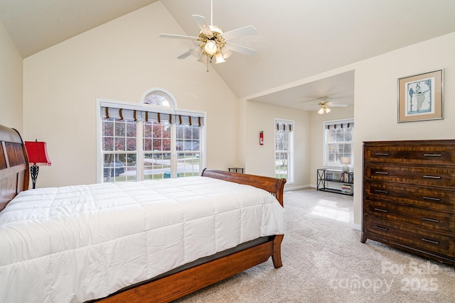 carpeted bedroom featuring ceiling fan and high vaulted ceiling