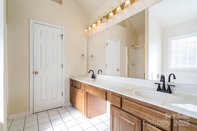 bathroom with tile patterned flooring, vanity, vaulted ceiling, and an enclosed shower