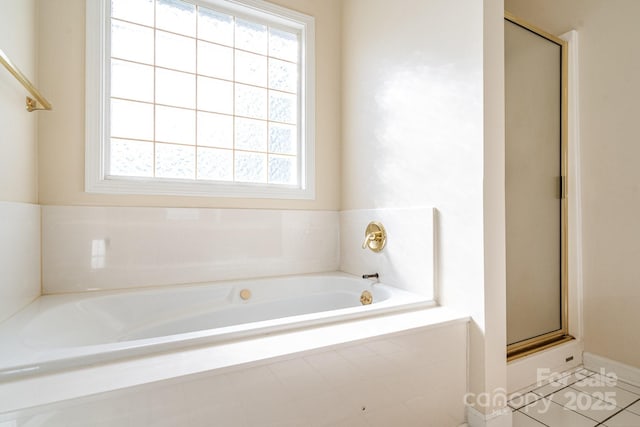 bathroom with separate shower and tub and tile patterned floors