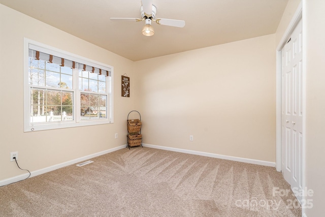 unfurnished bedroom with ceiling fan, carpet floors, and a closet