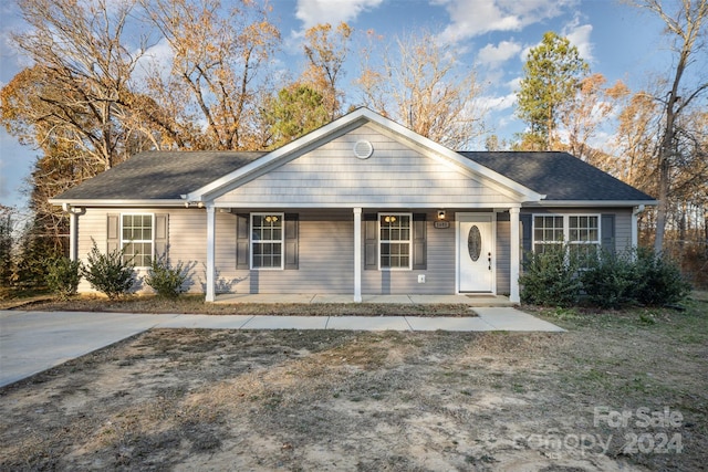 single story home with a porch