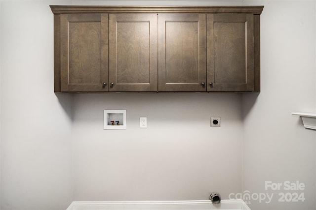 washroom with cabinets, washer hookup, and hookup for an electric dryer