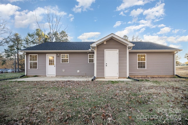 back of house featuring a yard and a patio area