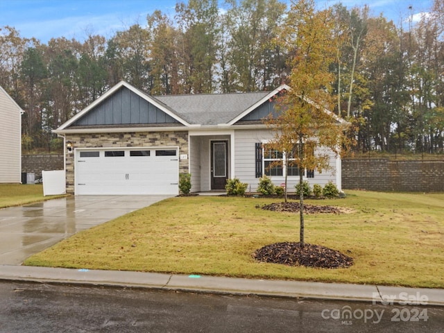 view of front of house with a front lawn and a garage