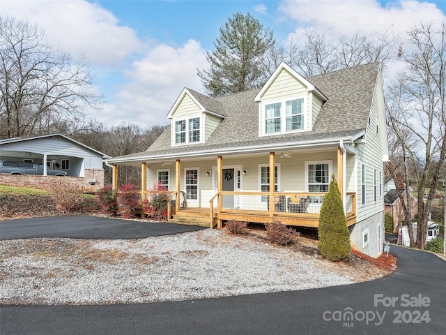 cape cod-style house featuring covered porch