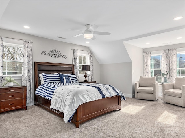 bedroom with ceiling fan, lofted ceiling, light carpet, and multiple windows