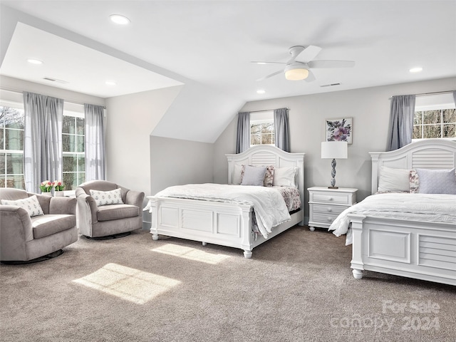 bedroom featuring multiple windows, dark carpet, ceiling fan, and lofted ceiling