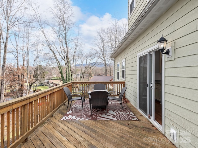 deck with outdoor dining area