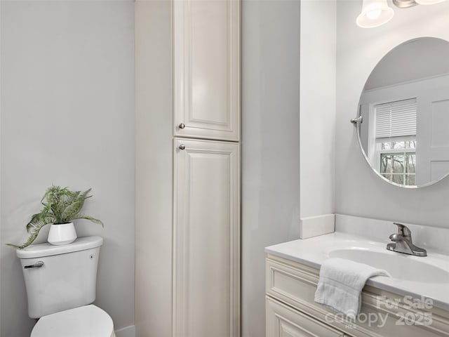 bathroom featuring vanity and toilet