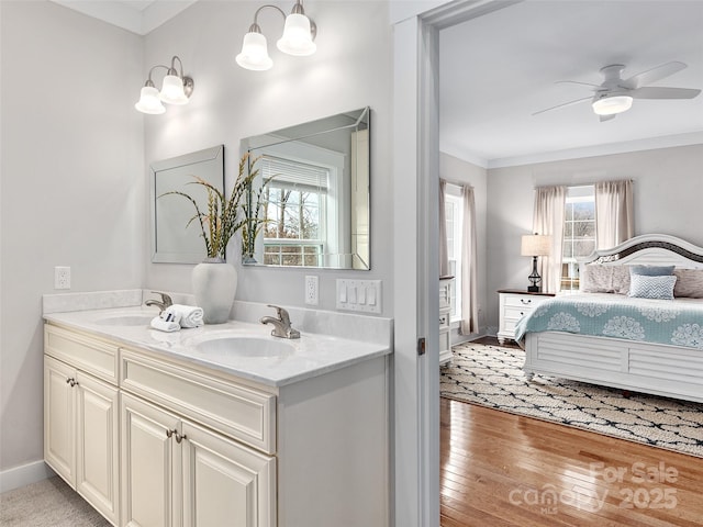 ensuite bathroom featuring double vanity, a ceiling fan, a sink, and ensuite bathroom