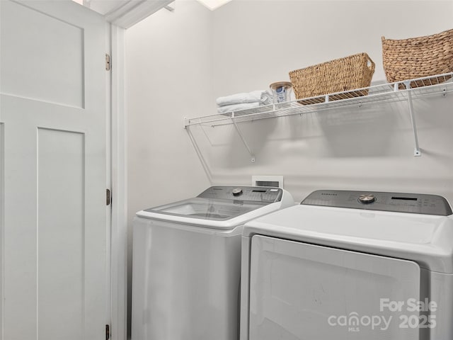 washroom with separate washer and dryer and laundry area