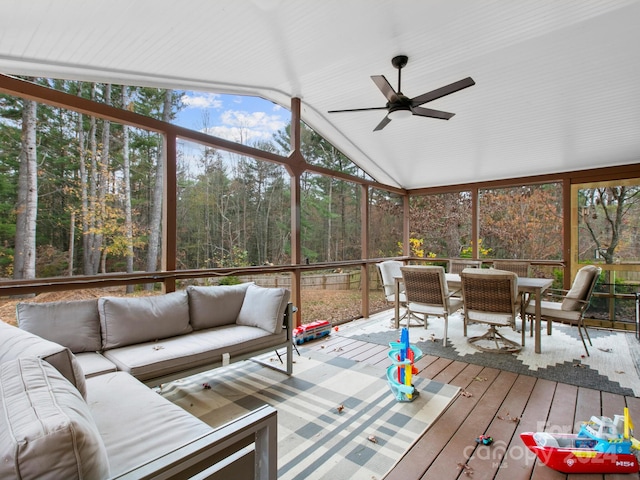 sunroom / solarium featuring ceiling fan, vaulted ceiling, and a healthy amount of sunlight