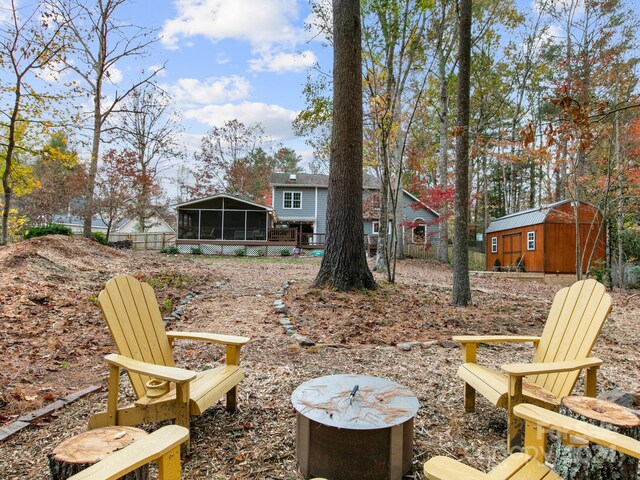 view of yard with a sunroom and a storage unit