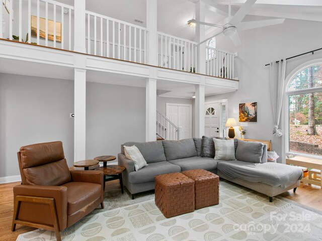 living room with high vaulted ceiling, hardwood / wood-style flooring, and ceiling fan