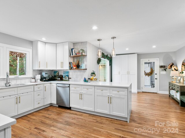 kitchen featuring dishwasher, white cabinetry, and light hardwood / wood-style floors