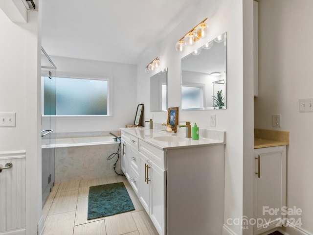 bathroom featuring tile patterned flooring, vanity, and plus walk in shower