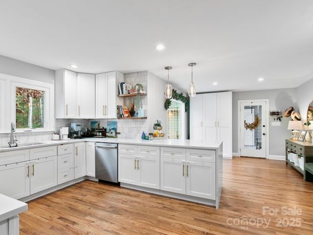 3 White Rock Ct, Arden, NC 28704 - kitchen with dishwasher, a sink, a peninsula, white cabinets, and tasteful backsplash