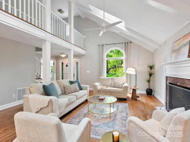 3 White Rock Ct, Arden, NC 28704 - living room featuring ceiling fan, a skylight, stairs, wood finished floors, and high vaulted ceiling