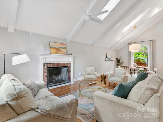3 White Rock Ct, Arden, NC 28704 - living room with wood finished floors, a brick fireplace, a skylight, a ceiling fan, and baseboards