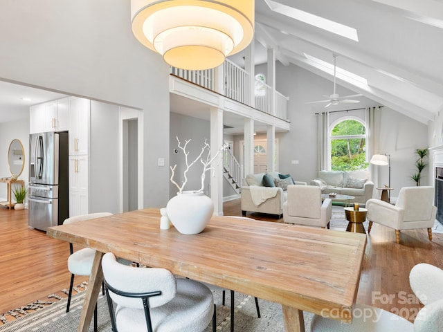 3 White Rock Ct, Arden, NC 28704 - dining area featuring high vaulted ceiling, light wood finished floors, stairway, beam ceiling, and a skylight