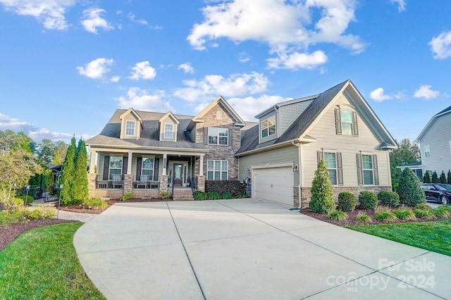 view of front of home with covered porch and a garage