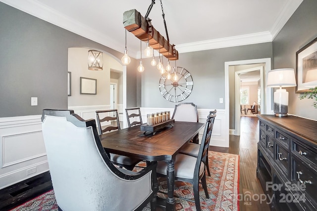 dining room featuring a notable chandelier, crown molding, and dark hardwood / wood-style flooring