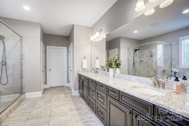 bathroom with vanity and a shower with shower door