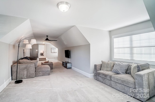 carpeted living room with ceiling fan and lofted ceiling