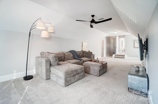 living room featuring ceiling fan, lofted ceiling, and light colored carpet