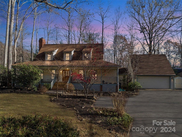 view of front facade with covered porch and a garage