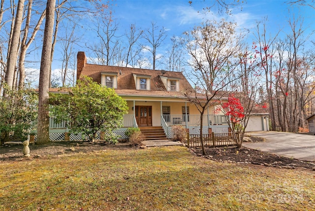 view of front of property with a front lawn, a porch, and a garage