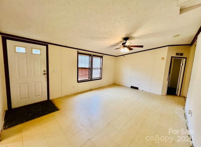 entryway with ceiling fan and a textured ceiling