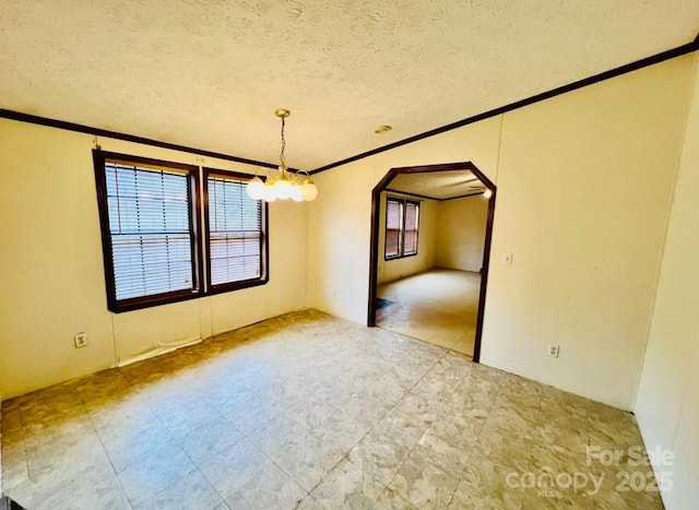 unfurnished dining area with ornamental molding, a textured ceiling, and a notable chandelier