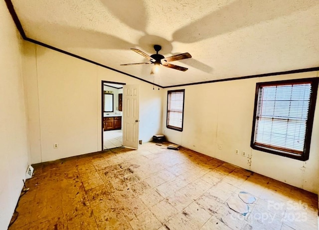 unfurnished bedroom with ceiling fan, ornamental molding, a textured ceiling, and vaulted ceiling