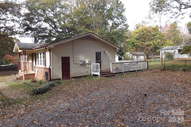 back of house featuring a wooden deck