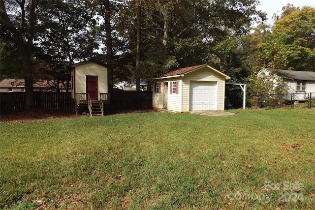 view of yard featuring an outbuilding and a garage