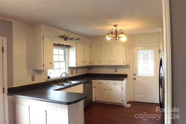 kitchen featuring dishwasher, white cabinetry, sink, and an inviting chandelier