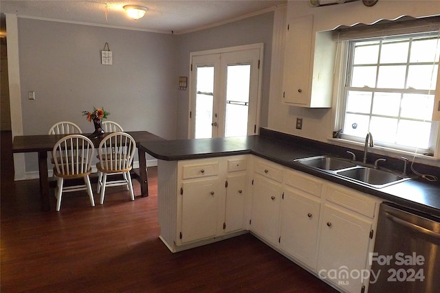 kitchen with dark wood-type flooring, dishwasher, kitchen peninsula, white cabinets, and sink