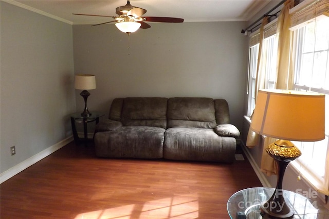 living room with ornamental molding, hardwood / wood-style floors, and ceiling fan