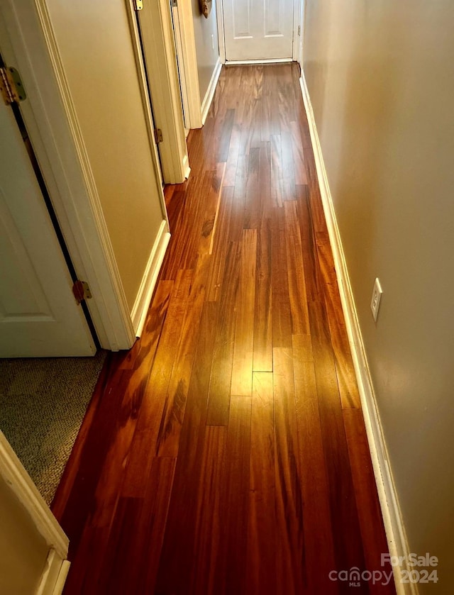 hallway with wood-type flooring