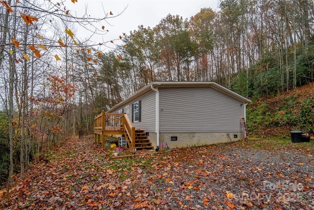 view of property exterior featuring a wooden deck